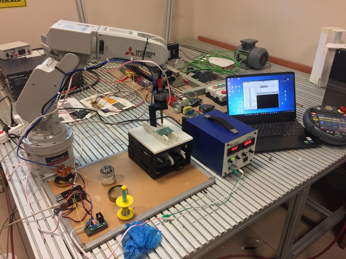 Robotic arm, power supply and controller on a lab bench
